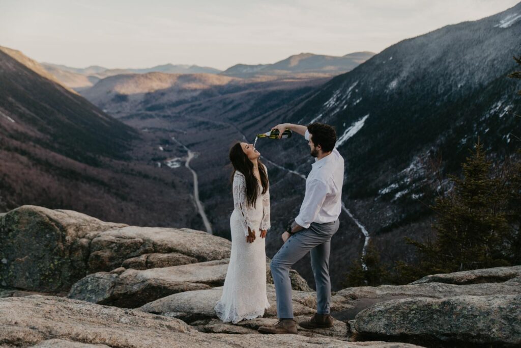 couple drinking champagne on a mountain new hampshire