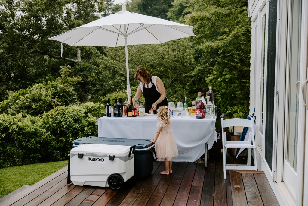 Wedding guests gathering on a deck surrounded by trees